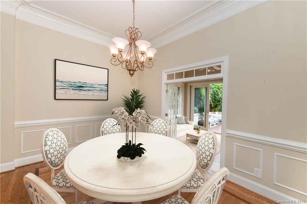 919 Colville Road Charlotte, NC 28207 - Photo 2 of 38 a dining room with furniture a large window and wooden floor