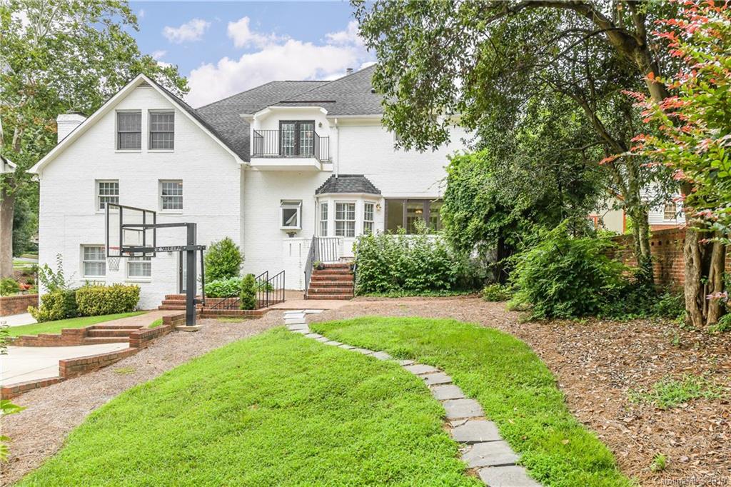 919 Colville Road Charlotte, NC 28207 - Photo 11 of 38 a front view of a house with a yard and potted plants
