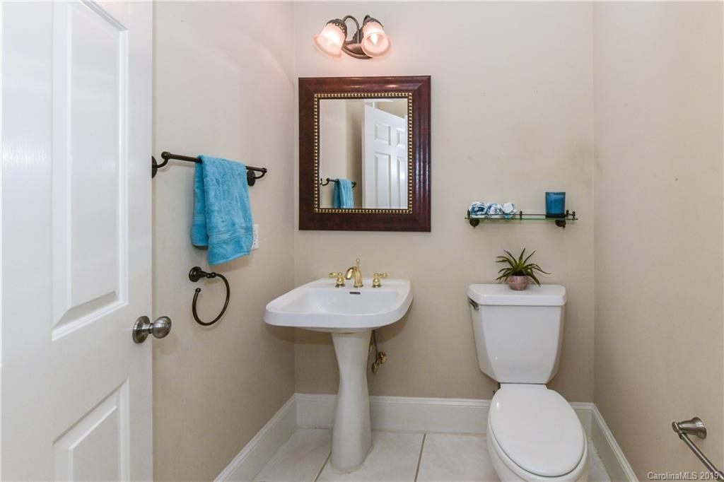 919 Colville Road Charlotte, NC 28207 - Photo 12 of 38 a bathroom with a toilet sink and mirror