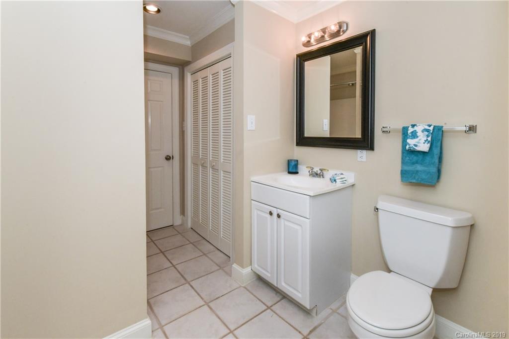 919 Colville Road Charlotte, NC 28207 - Photo 28 of 38 a bathroom with a toilet sink vanity and mirror