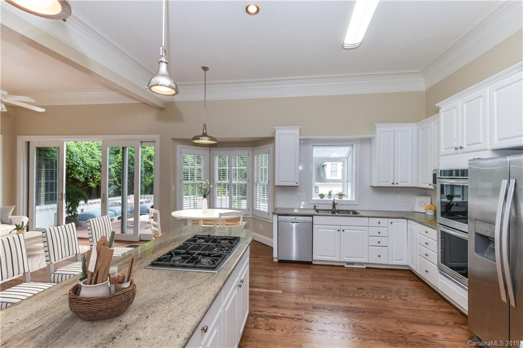 919 Colville Road Charlotte, NC 28207 - Photo 4 of 38 a kitchen with stainless steel appliances granite countertop a sink and a stove