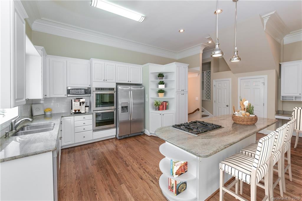 919 Colville Road Charlotte, NC 28207 - Photo 5 of 38 a kitchen with granite countertop a sink appliances and wooden floor