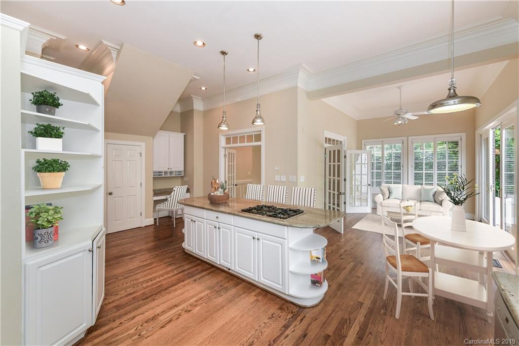 919 Colville Road Charlotte, NC 28207 - Photo 6 of 38 a large kitchen with kitchen island a large window a sink and stainless steel appliances
