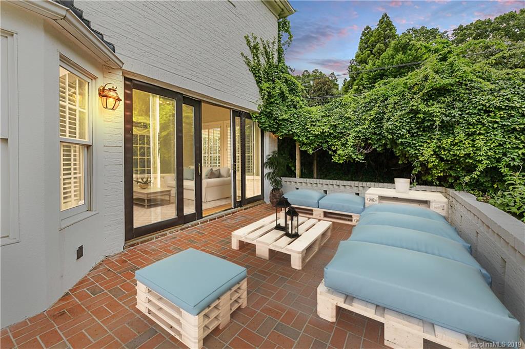 919 Colville Road Charlotte, NC 28207 - Photo 8 of 38 a view of a patio with couches table and chairs and potted plants