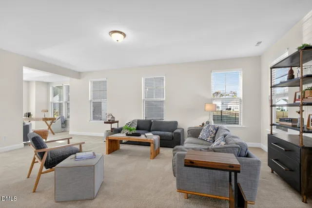 a living room with furniture and a book shelf