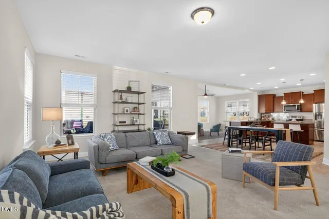 a living room with furniture and view of kitchen