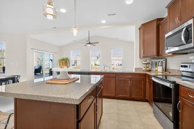a kitchen with stainless steel appliances granite countertop a sink and stove
