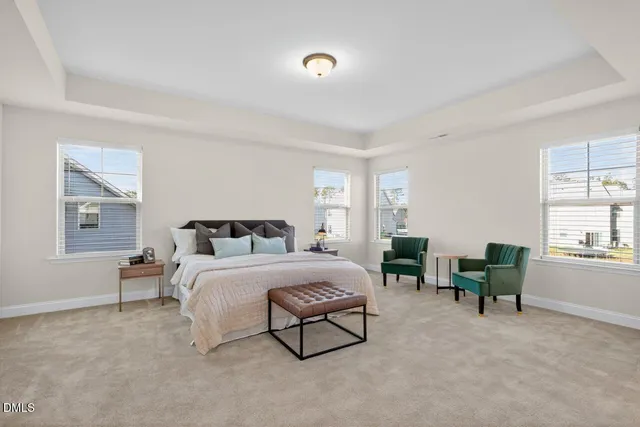 a spacious bedroom with a bed a couch and a window