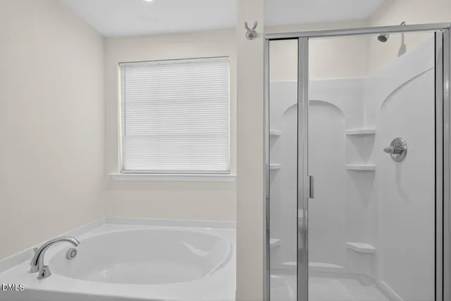 a white bath tub with a shower