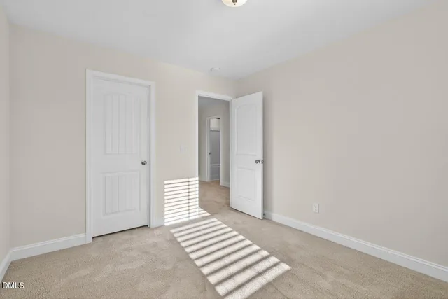 a view of a livingroom with wooden floor and white walls