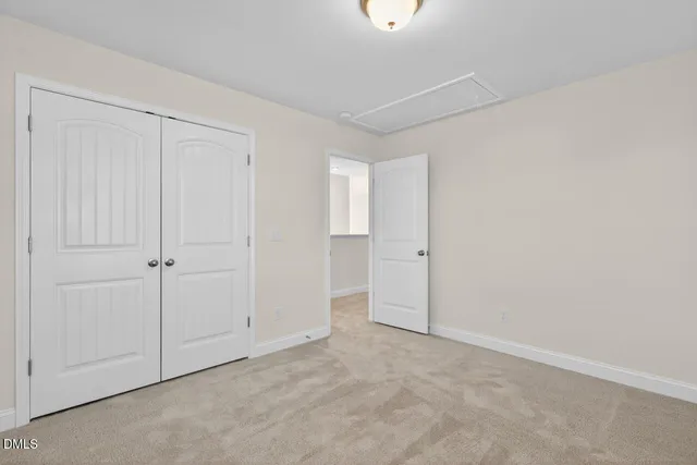 an empty room with closet area