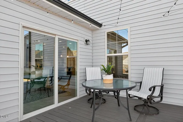 a balcony with table and chairs