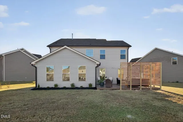 a view of a house with backyard and garage