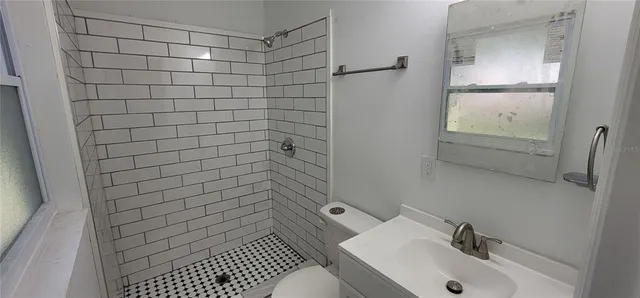 a bathroom with a sink toilet and shower