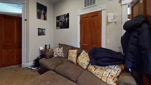 a living room with furniture and a closet