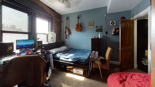 a bedroom with bed and a closet