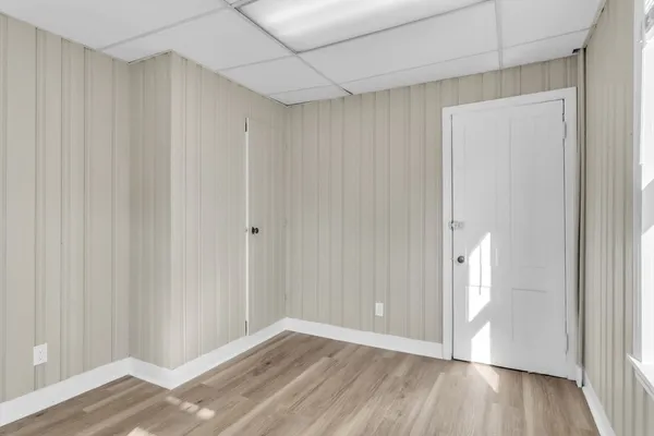 a view of an empty room with wooden floor