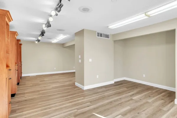 a view of a room with wooden floor and ceiling fan