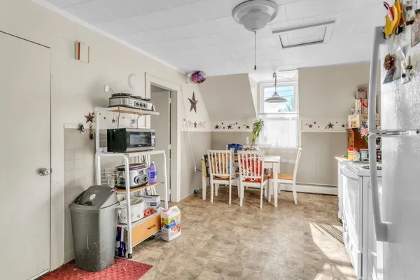 a bedroom with bed and a potted plant