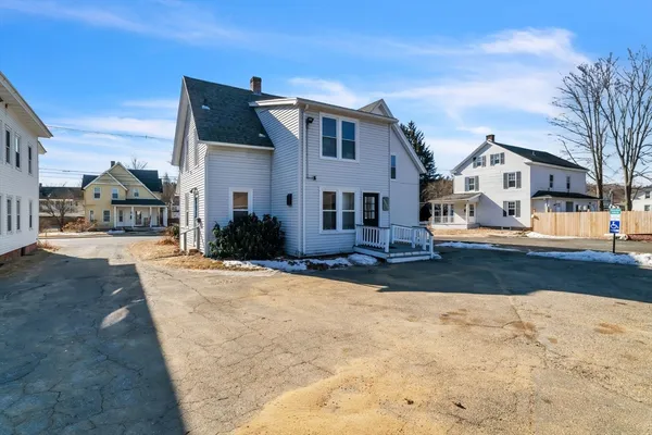 a view of a house with wooden deck front of house