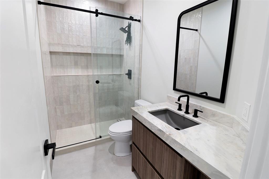 10303 Southwest 26th Street Davie, FL 33324 - Photo 17 of 35 a bathroom with a sink a toilet and shower