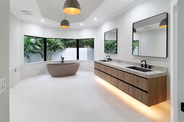 a large white room with a large window and a sink