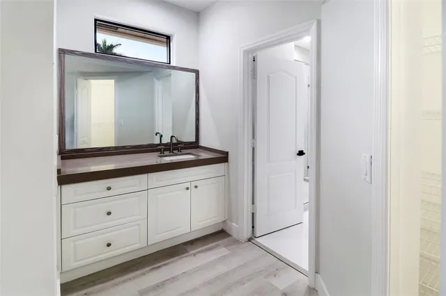 a bathroom with a double vanity sink and a mirror