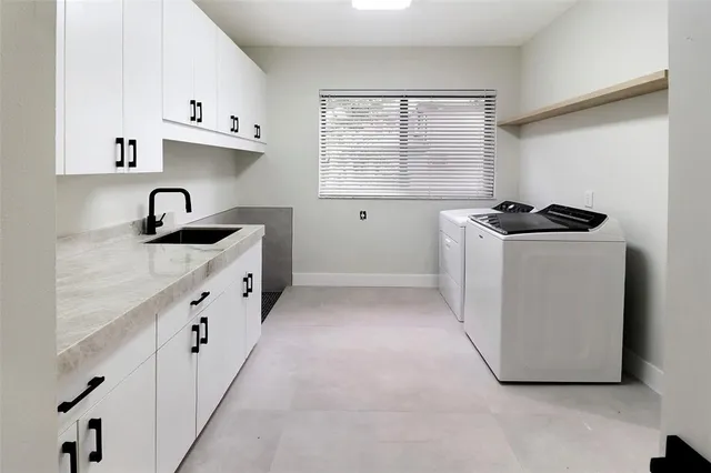 a kitchen with granite countertop a sink stove and cabinets