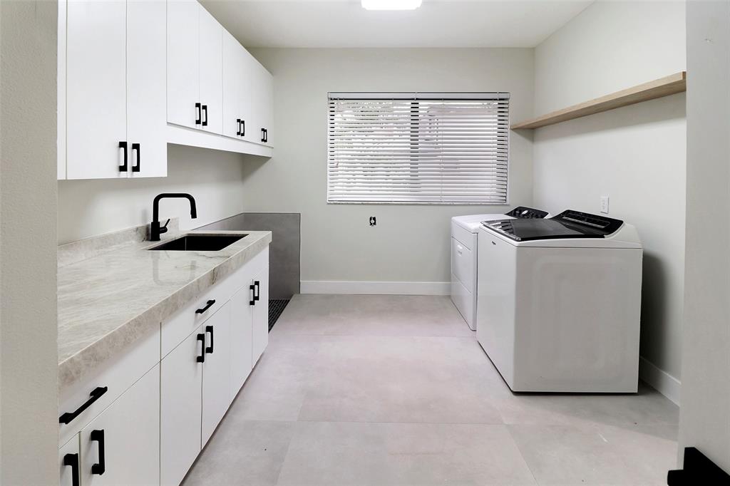 10303 Southwest 26th Street Davie, FL 33324 - Photo 31 of 35 a kitchen with granite countertop a sink stove and cabinets