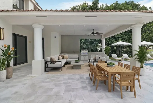 a view of a patio with dining table and chairs with plants