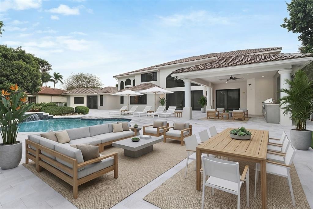 10303 Southwest 26th Street Davie, FL 33324 - Photo 34 of 35 a view of a patio with couches table and chairs and potted plants