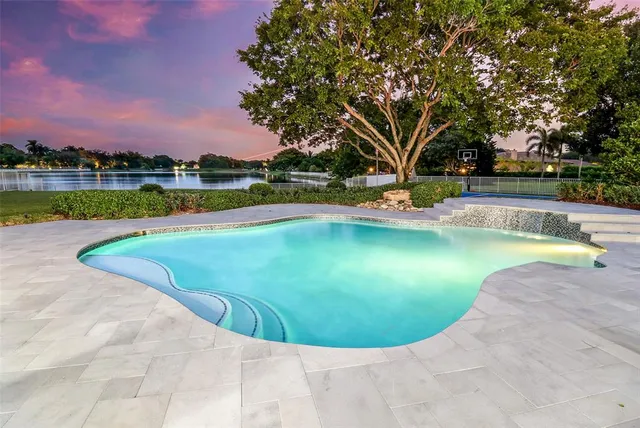 a view of a swimming pool with a yard
