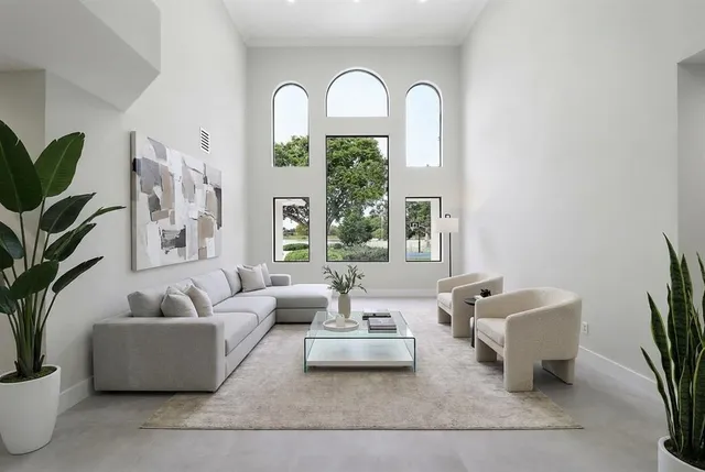 a living room with furniture and a potted plant