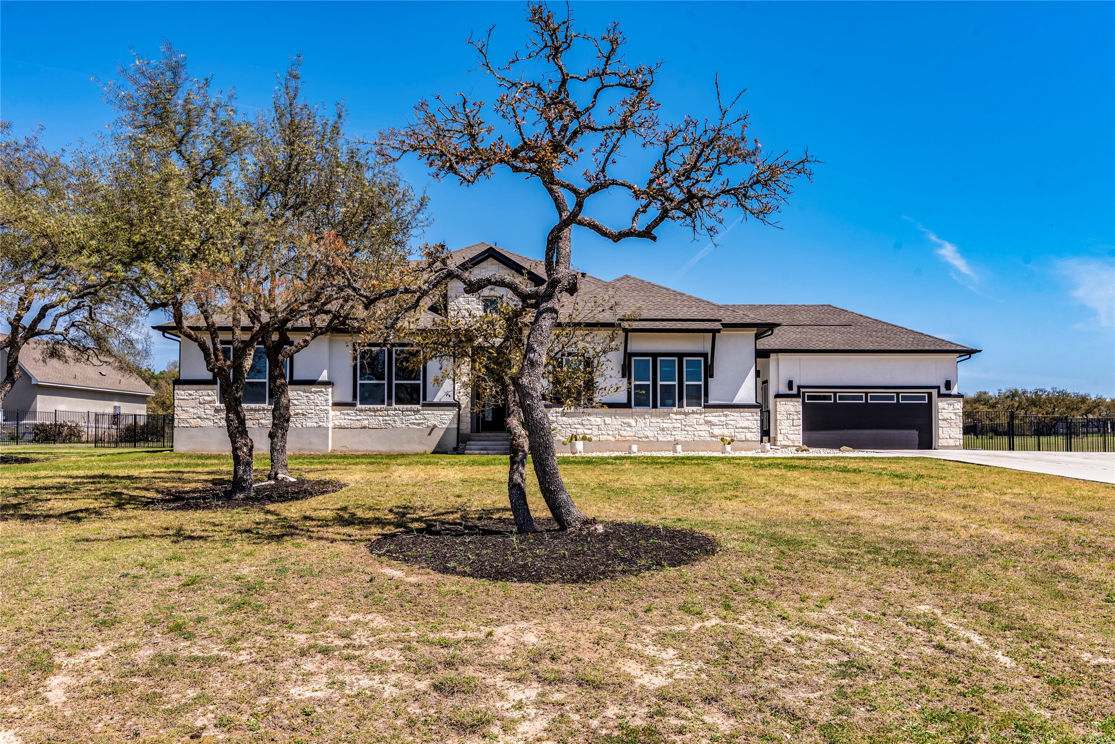 231 Call Drive Austin, TX 78737 - Photo 1 of 1 View from the street 4 car garage and extended Driveway