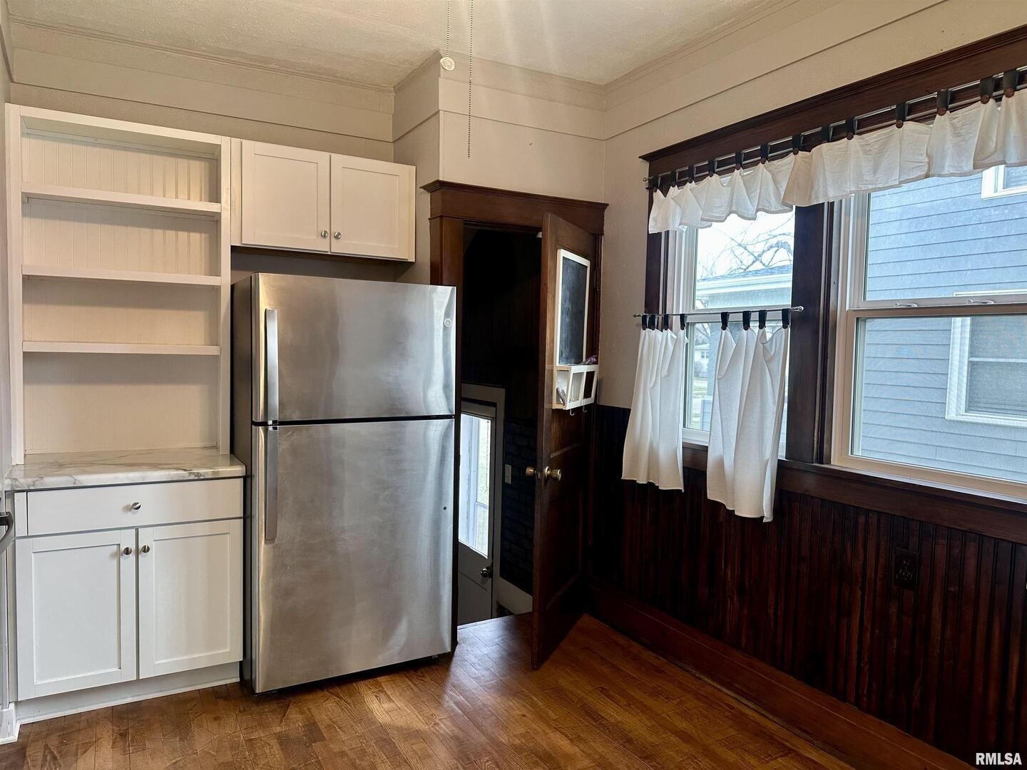 811 7th Avenue South Clinton, IA 52732 - Photo 13 of 27 a kitchen with a refrigerator and a wooden floor