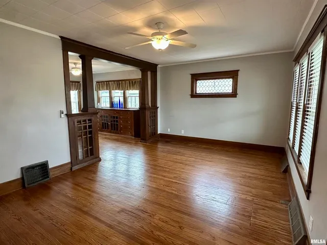 wooden floor in an empty room with a window
