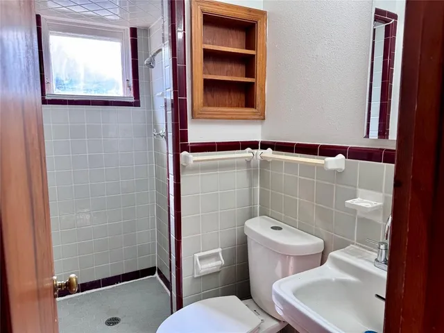 a bathroom with a toilet and a shower