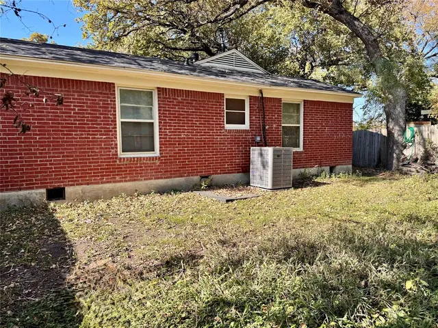 a backyard of a house with barbeque oven
