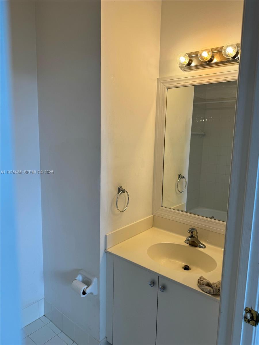 669 Northwest 42nd Avenue Plantation, FL 33317 - Photo 13 of 14 a bathroom with a sink and a mirror