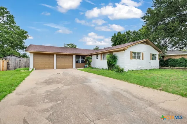 a front view of house with yard and green space