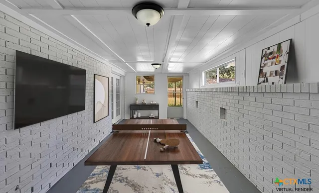 a living room with a flat screen tv and a fireplace