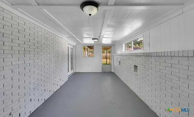 a view of a hallway to rooms and stairs