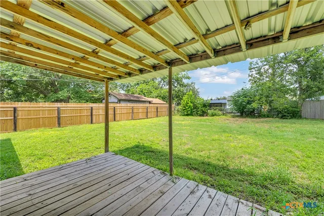 a view of a backyard with wooden floor