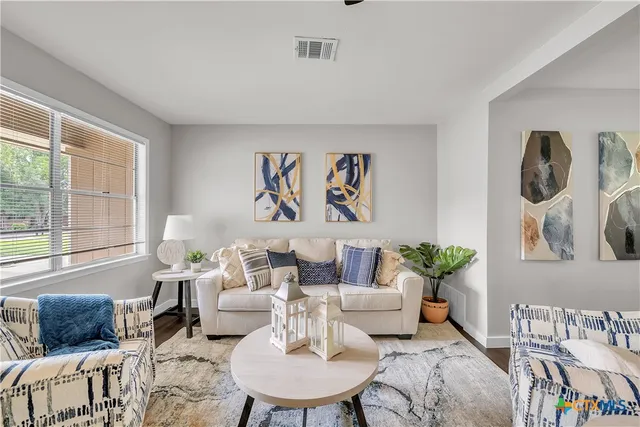a living room with furniture and a large window