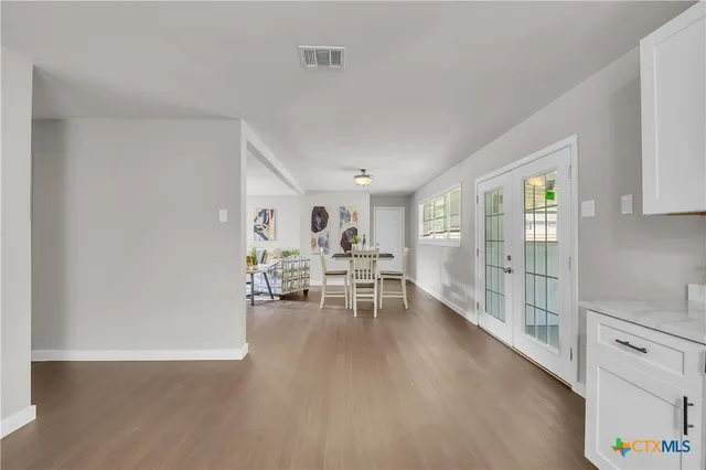 a dining room with furniture and wooden floor