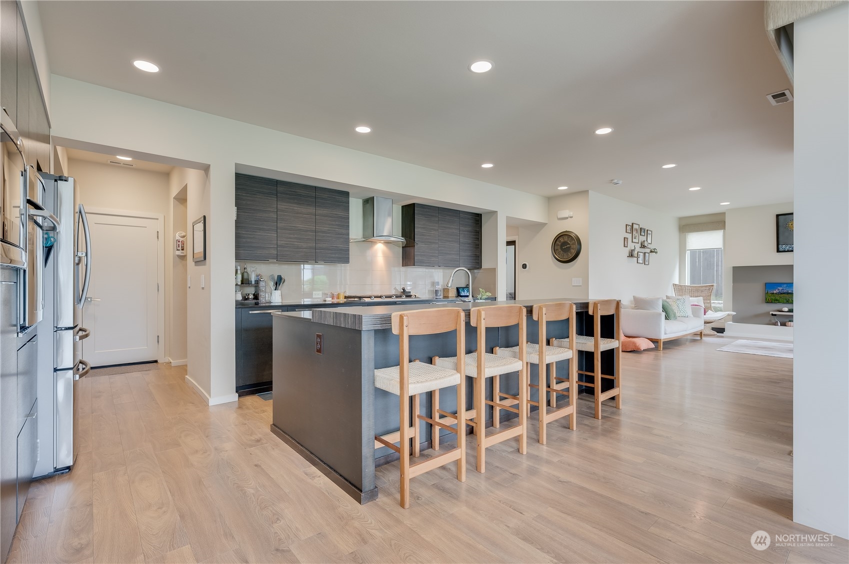 4016 171st Street Southeast Bothell, WA 98012 - Photo 12 of 39 a kitchen with stainless steel appliances kitchen island granite countertop a refrigerator and cabinets