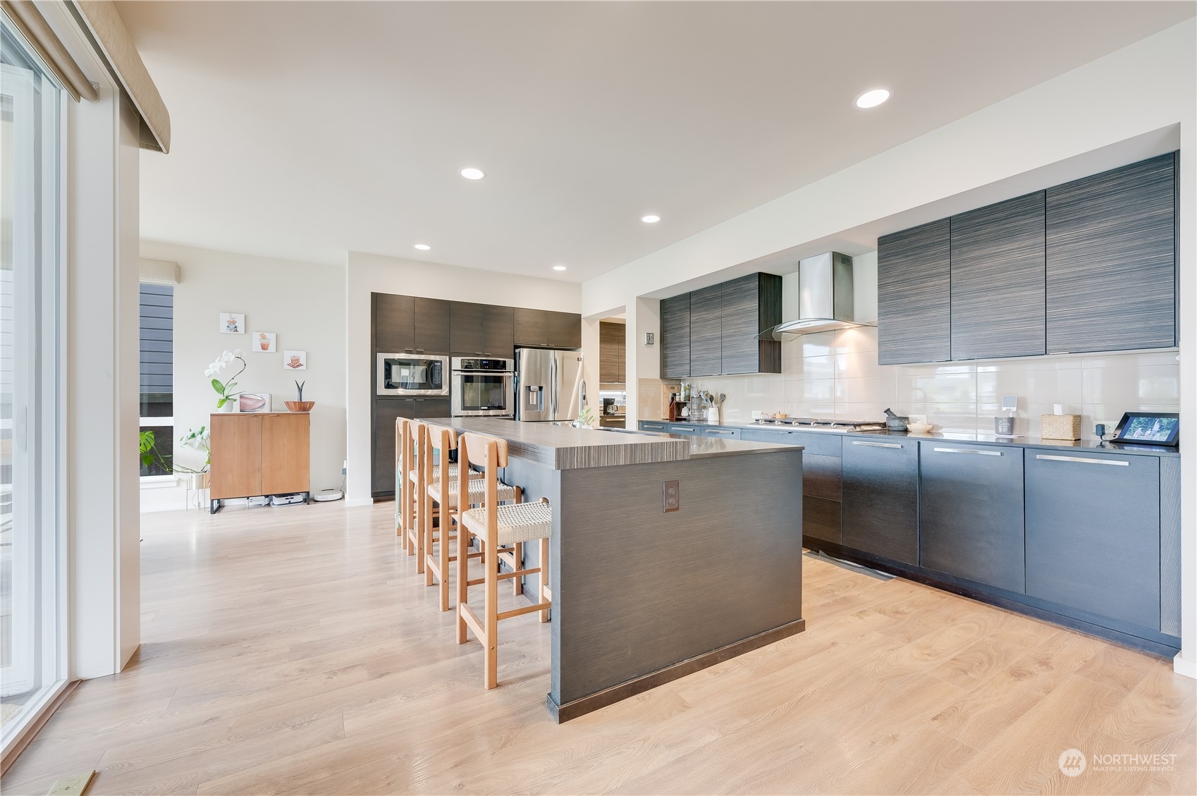 4016 171st Street Southeast Bothell, WA 98012 - Photo 14 of 39 a kitchen with stainless steel appliances kitchen island granite countertop a refrigerator and a sink