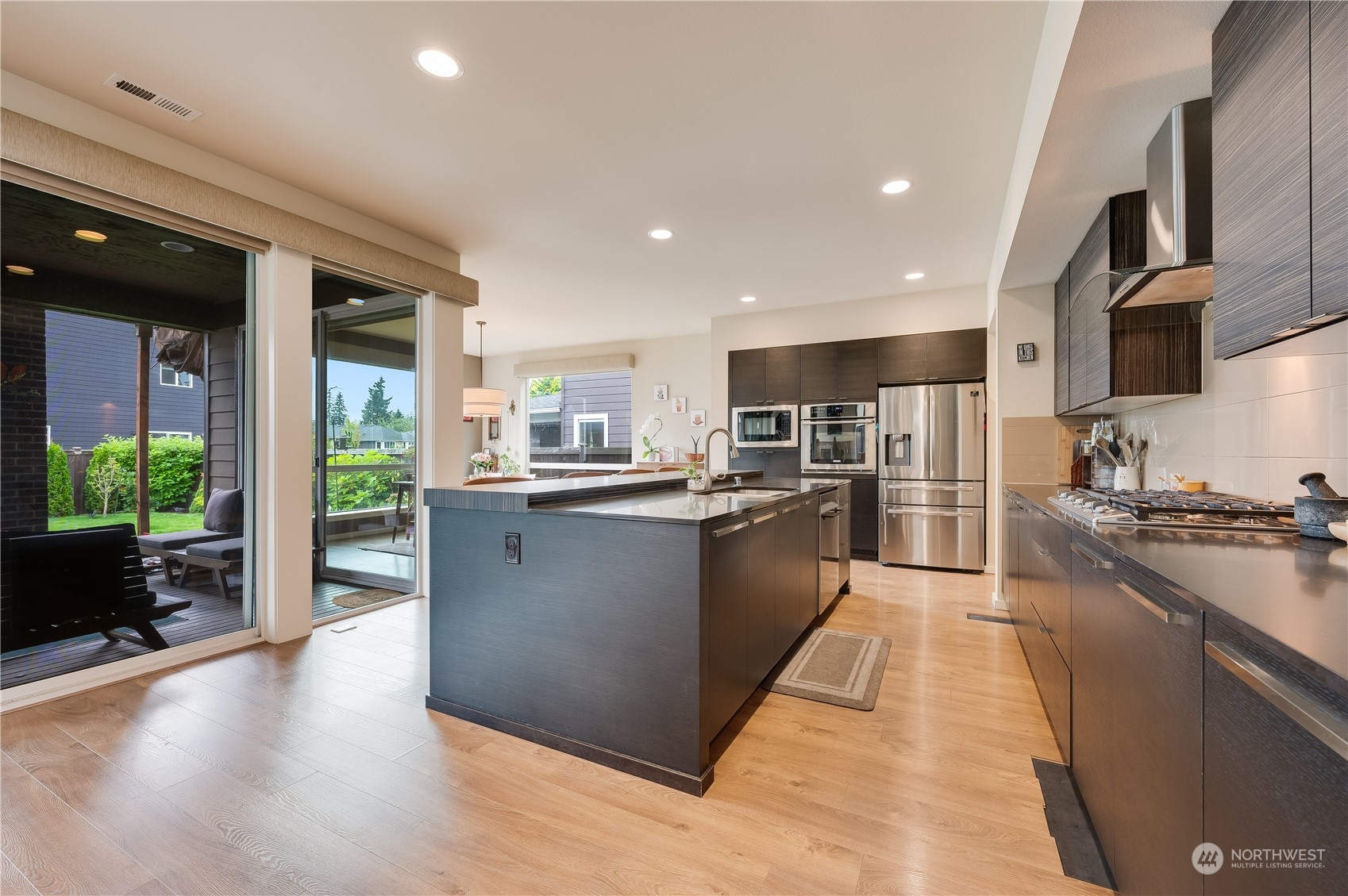 4016 171st Street Southeast Bothell, WA 98012 - Photo 15 of 39 a large kitchen with stainless steel appliances kitchen island granite countertop a large counter top and a stove top oven
