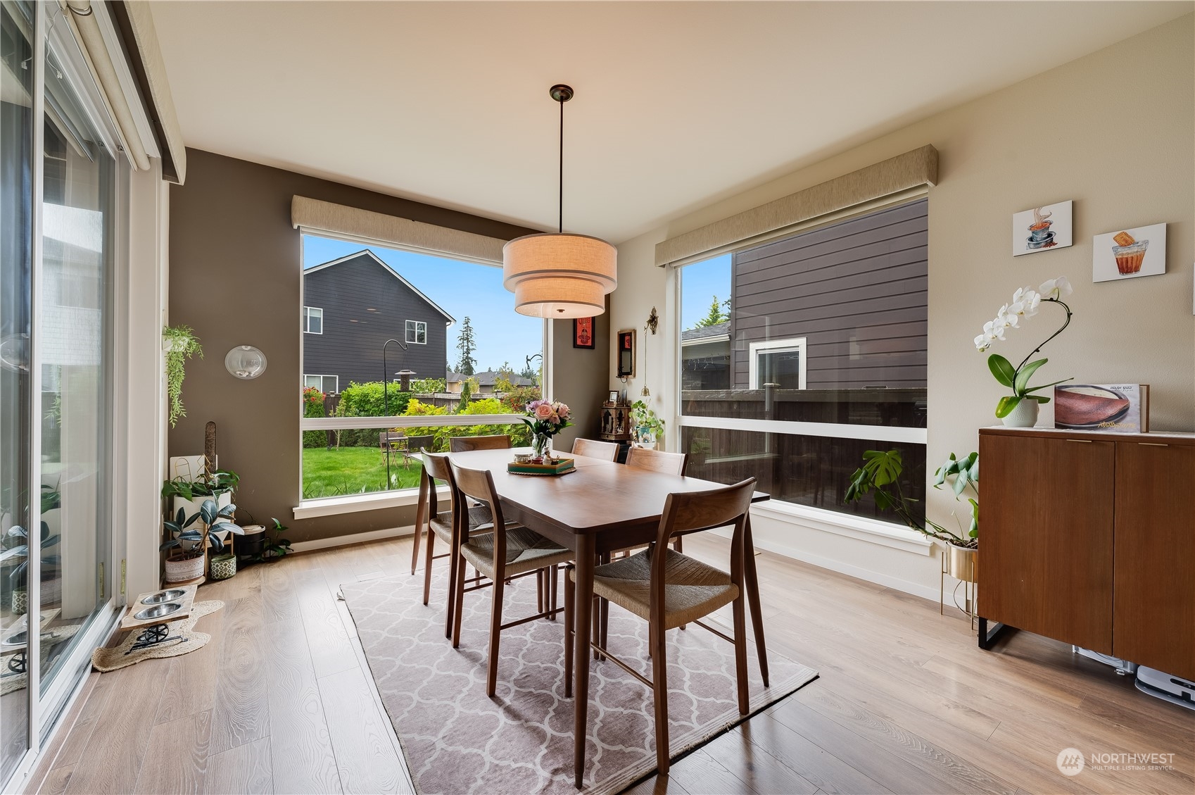 4016 171st Street Southeast Bothell, WA 98012 - Photo 18 of 39 a dining room with furniture a chandelier and wooden floor