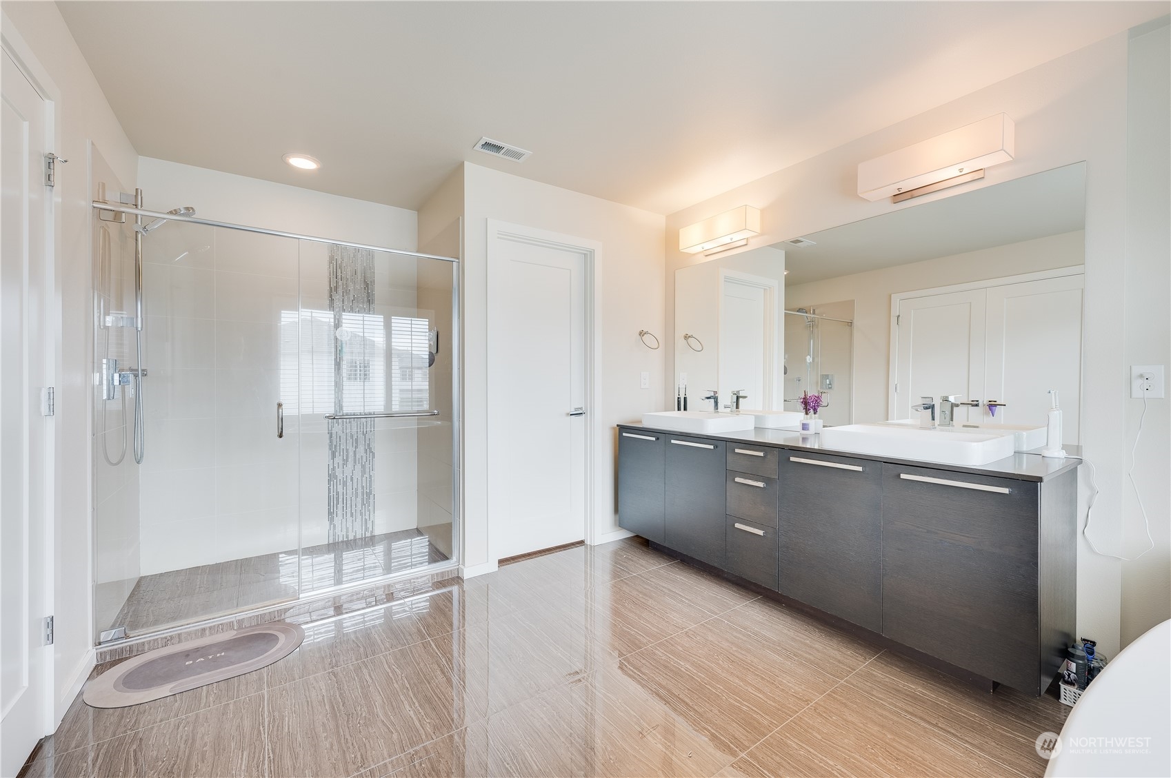 4016 171st Street Southeast Bothell, WA 98012 - Photo 25 of 39 a large bathroom with a large mirror vanity and shower